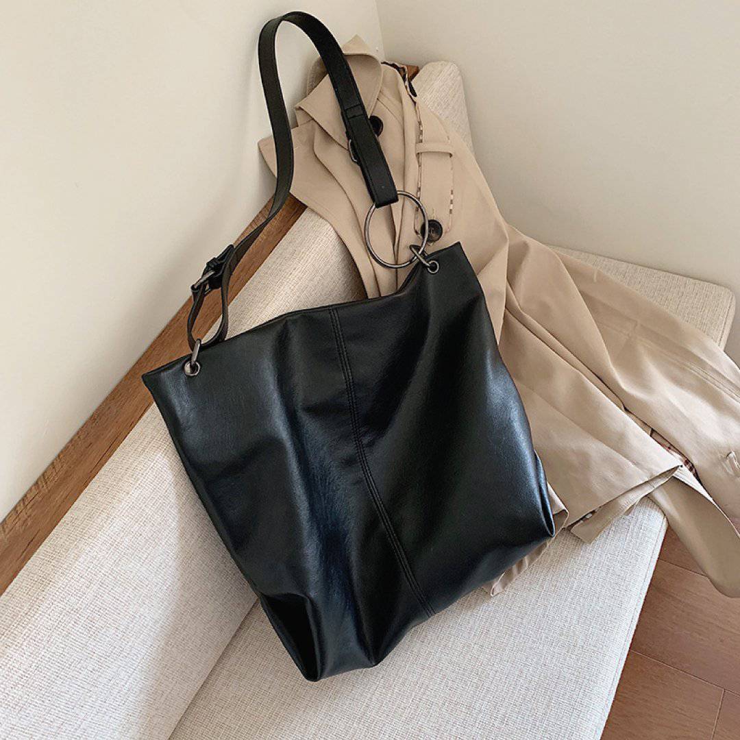 Nehwei Enterprise CeCe Shoulder Bag in sleek black leather with silver hardware and adjustable strap.