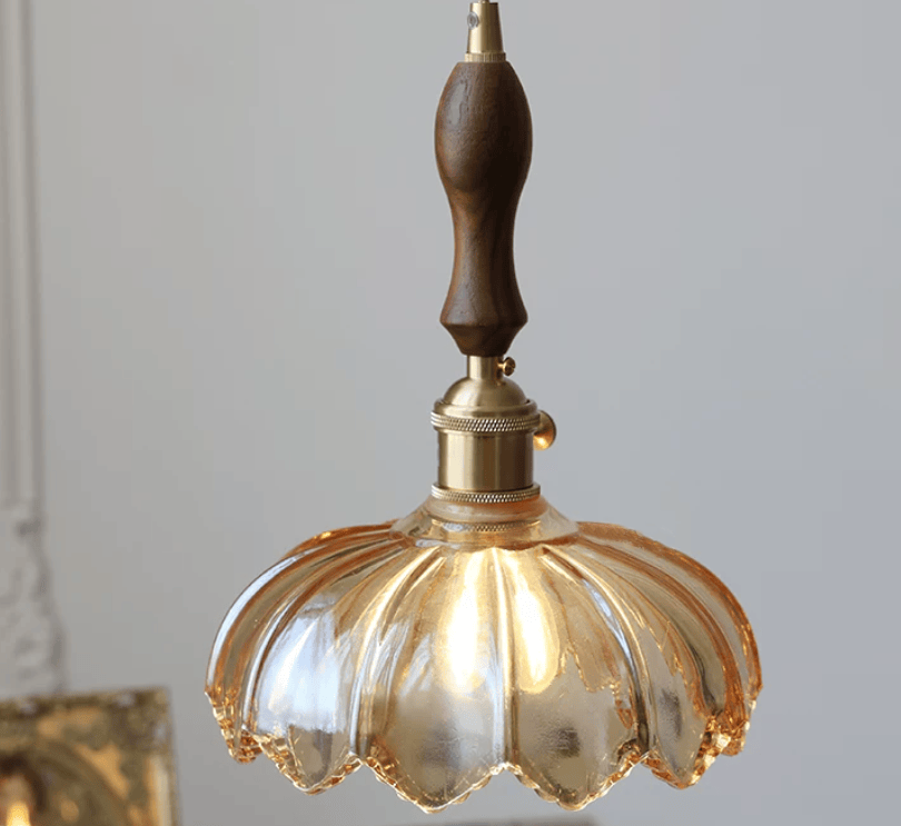 Vintage glass flower pendant light by eprolo featuring a minimalist design with a clear glass flower shade hanging from a sleek fixture.