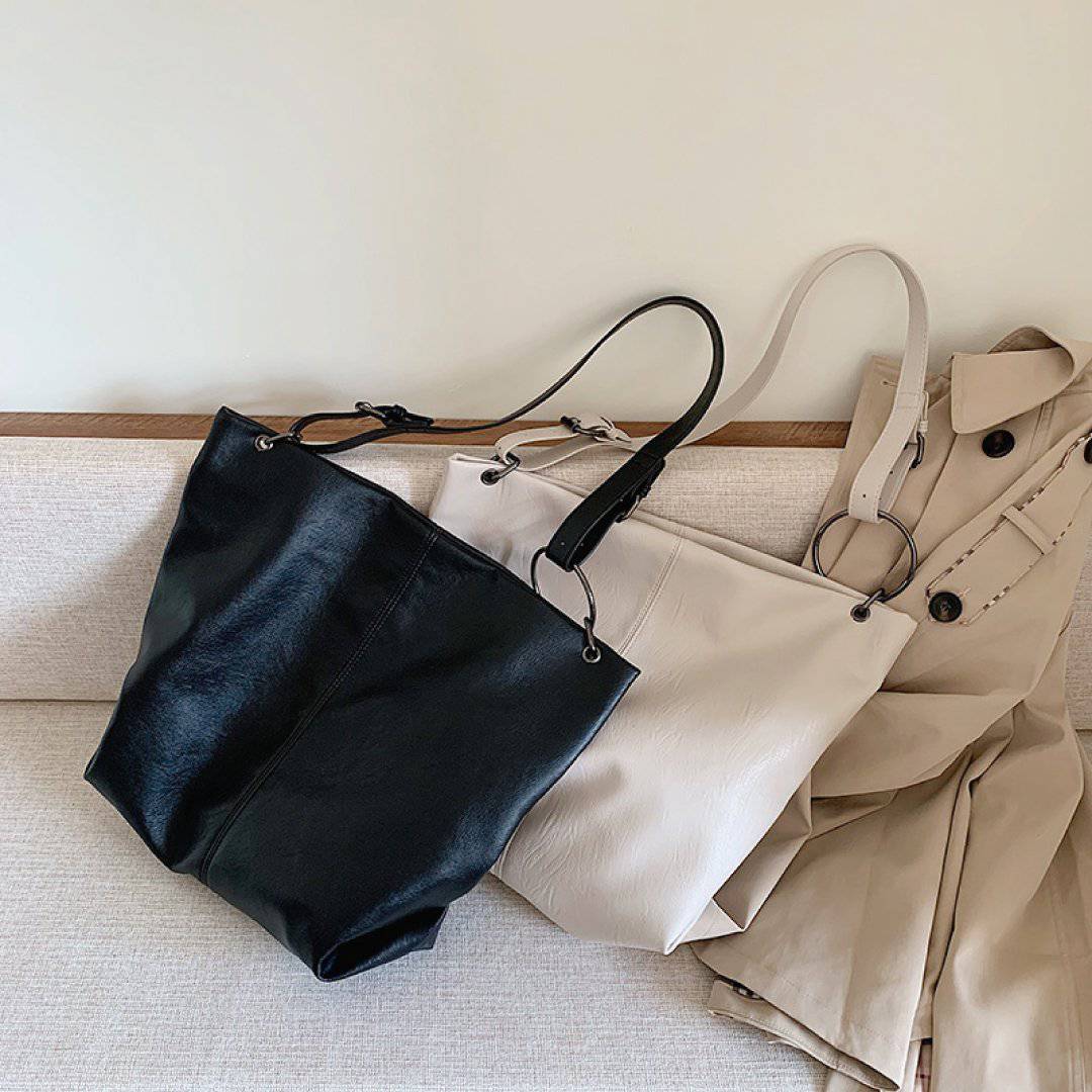 Nehwei Enterprise CeCe shoulder bag in black leather with gold-tone hardware and adjustable strap.