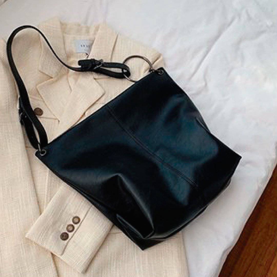 Nehwei Enterprise CeCe shoulder bag featuring a sleek design, black leather with silver hardware, and adjustable strap.