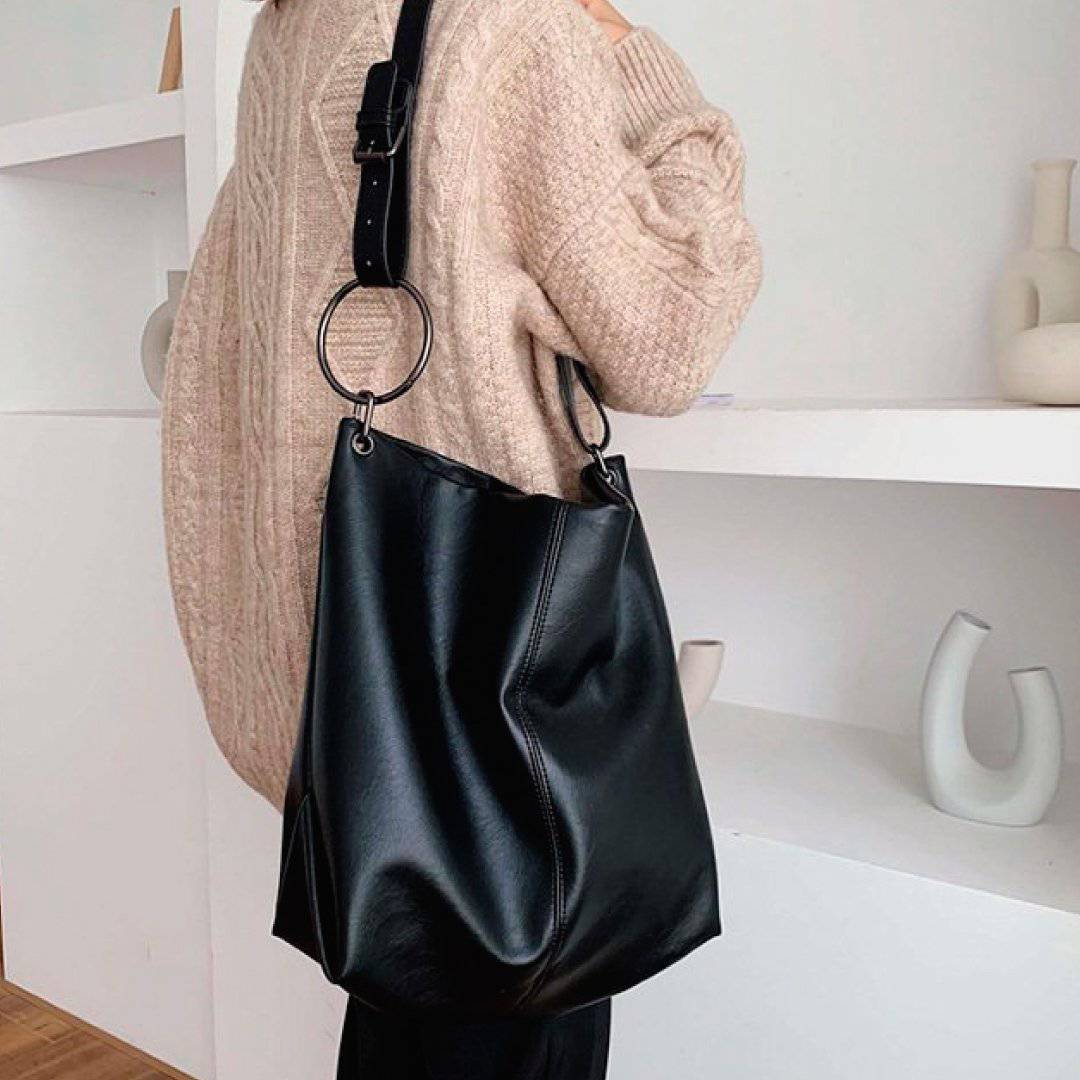 Nehwei Enterprise CeCe shoulder bag in black with gold hardware, stylish leather design, and adjustable strap.