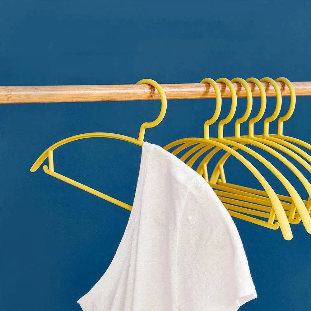 Plastic household clothes hanger with wide shoulder and semi-circular design, ideal for organizing garments seamlessly.