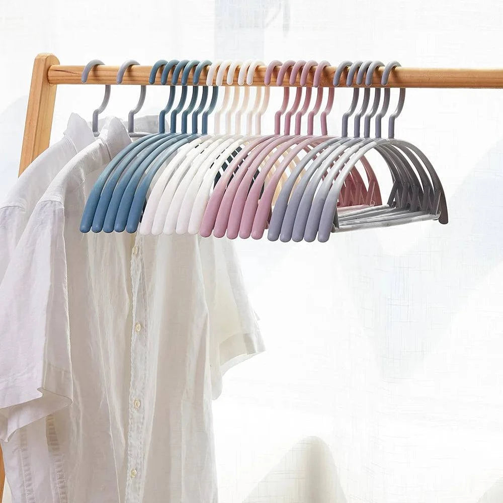 Plastic household clothes hanger with wide shoulders and semi-circular design, seamless for organizing garments efficiently.