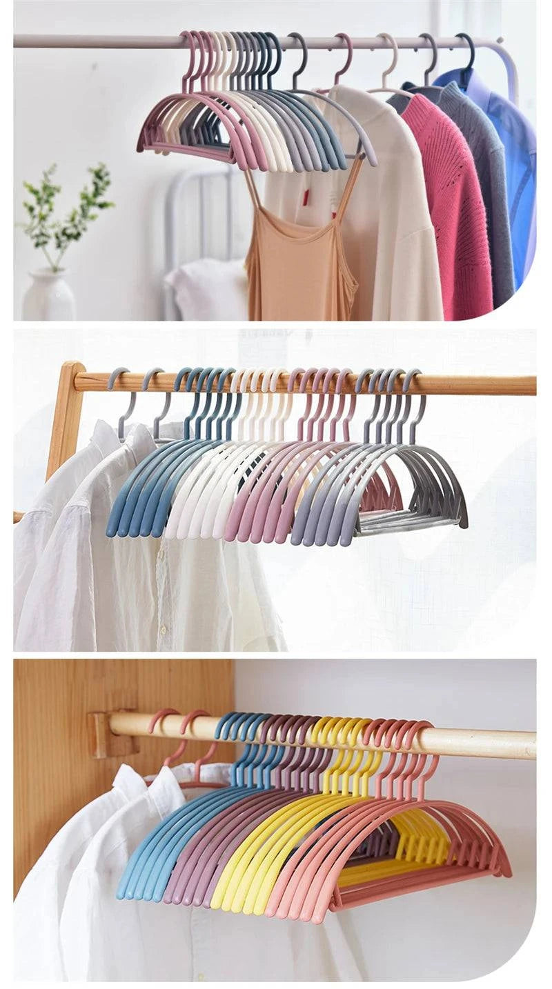 Plastic household clothes hanger with wide shoulders and semi-circular design, ideal for seamless garment hanging and organization.