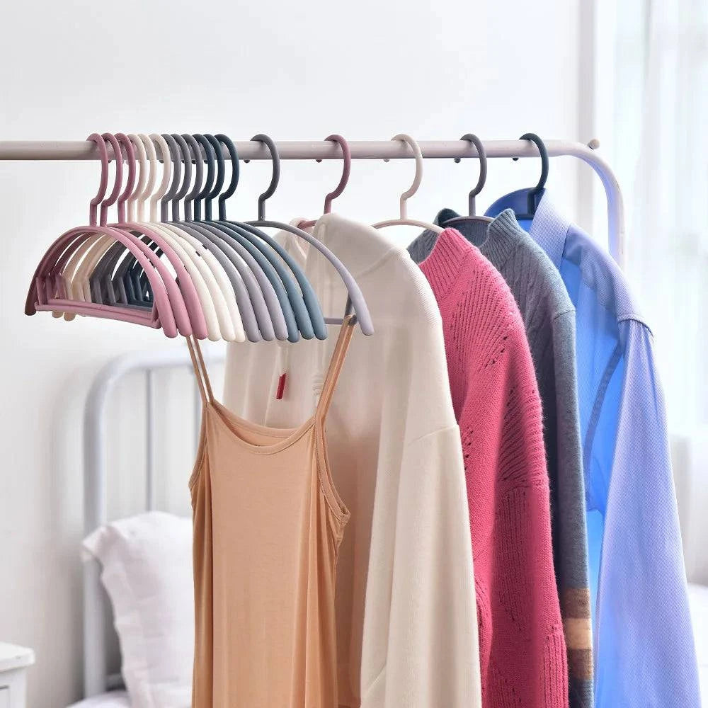 Plastic household clothes hanger with wide shoulder arc design and semi-circular shape, ideal for seamless hanging organization.