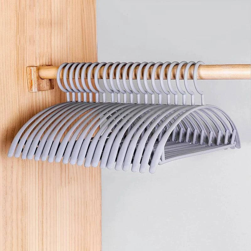 Plastic household clothes hanger with wide shoulders and semi-circular design, ideal for seamless organization by Nehwei enterprise