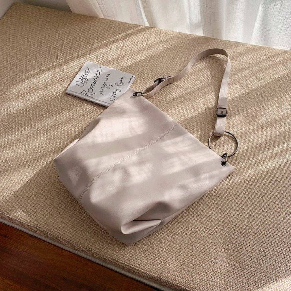 Nehwei enterprise CeCe shoulder bag in beige with adjustable strap and gold hardware, displayed on a plain background.